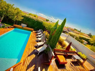 a pool with chaise lounge chairs and a bunch at Villa Felin Feline in LʼIsle-sur-la-Sorgue