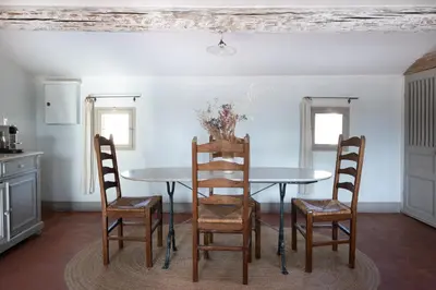 a dining room with a table and chairs at La Madone in Apt
