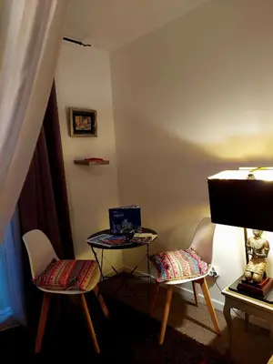 a room with two chairs and a table with a laptop at Les Jardins d'Eleusis in Murs