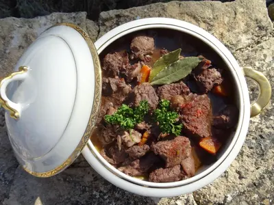 a pot of stew with meat and vegetables in it at Les Jardins d'Eleusis in Murs