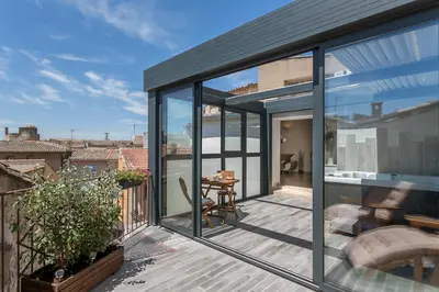 a glass house with a view of the city at Nuit Etoilée in LʼIsle-sur-la-Sorgue