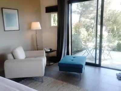 a living room with a couch and a chair and a window at La Maison de Charlie in Vaugines