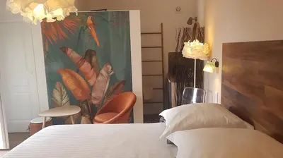 a bedroom with a bed and a painting on the wall at La Maison de Charlie in Vaugines