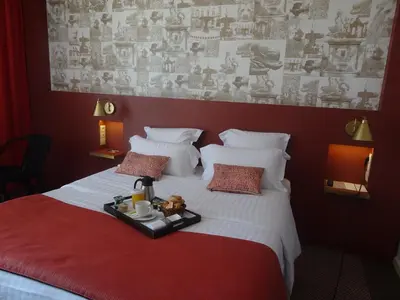 a bedroom with a bed with a tray on it at Aquabella Hôtel & Spa in Aix-en-Provence