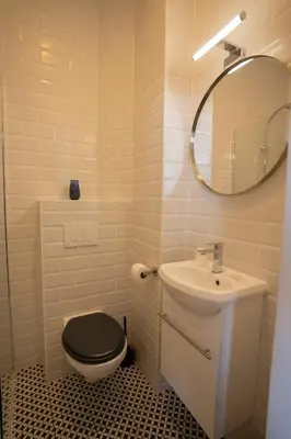 a bathroom with a toilet and a sink and a mirror at Hôtel d'Angleterre, Salon-de-Provence in Salon-de-Provence