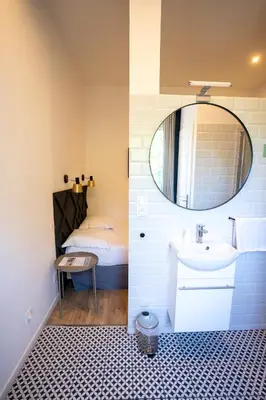 a bathroom with a sink and a mirror at Hôtel d'Angleterre, Salon-de-Provence in Salon-de-Provence