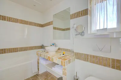 a bathroom with a sink and a mirror at Omma in Roussillon