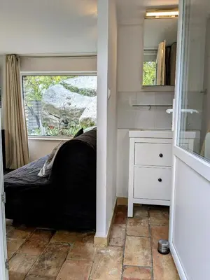 a small bedroom with a bed and a window at Les Rapieres Mireio in Gordes