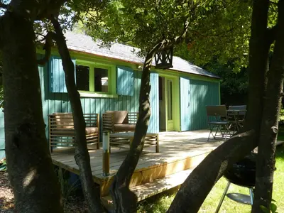a wooden deck in front of a house at Le Cabanon in Le Thor