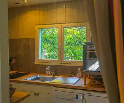 a kitchen with a sink and a window at Le Cabanon in Le Thor