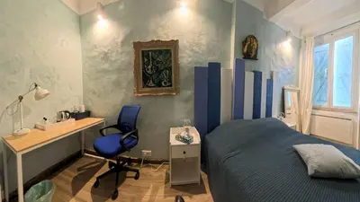 a bedroom with a bed and a desk and a chair at Le 47 - Rentals in South of France in Beaumont-de-Pertuis