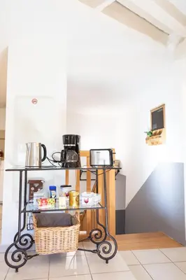 a kitchen with a table with food on it at Appartement spacieux Rochereau in LʼIsle-sur-la-Sorgue