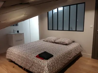 a bedroom with a bed with a black bag on it at The Panoramic House in Lagnes
