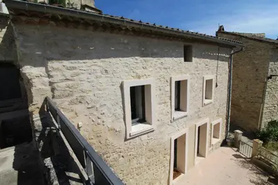 a stone building with four windows on it at The Panoramic House in Lagnes