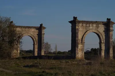 an old stone arch bridge in a field at le clos des sources in Saint-Chamas