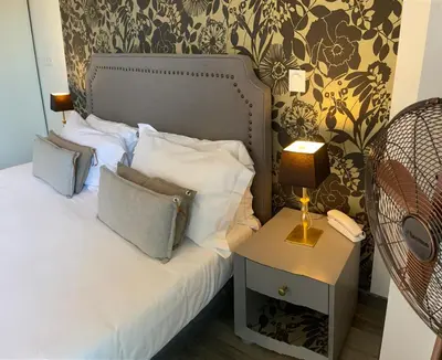 a bedroom with a bed with a side table and a phone at Les Terrasses D'Aix - Studio avec Grande Terrasse privée in Aix-en-Provence