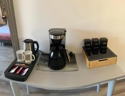 a table with a coffee maker and cups on it at Les Terrasses D'Aix - Studio avec Grande Terrasse privée in Aix-en-Provence