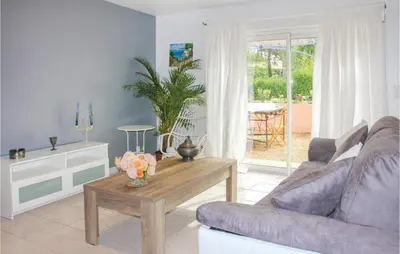 a living room with a couch and a table at Amazing Home In Lançon De Provence in Lançon-Provence