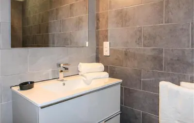 a bathroom with a sink and a mirror at Amazing Home In Lançon De Provence in Lançon-Provence