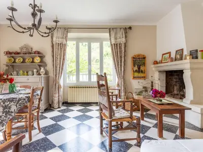 a living room with a table and chairs and a fireplace at Holiday Home Le Cèdre by Interhome in Ménerbes