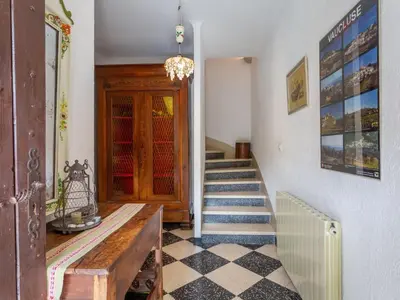 a hallway with a stairway with a wooden door at Holiday Home Le Cèdre by Interhome in Ménerbes