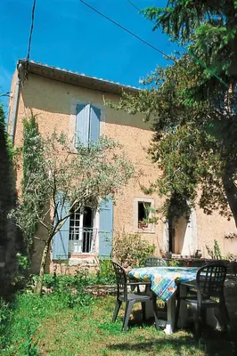 a table and chairs in front of a house at Holiday Home Le Cèdre by Interhome in Ménerbes
