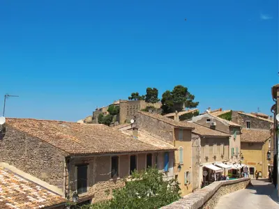 a view of a village with a hill in the background at Holiday Home Le Cèdre by Interhome in Ménerbes