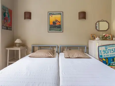 two beds sitting next to each other in a bedroom at Holiday Home Le Cèdre by Interhome in Ménerbes