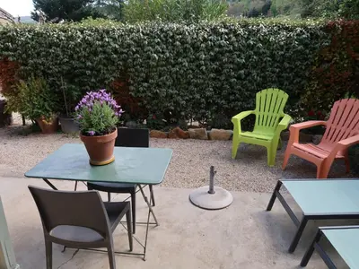 a group of chairs and tables in a yard at Holiday Home L'Olivier by Interhome in Ménerbes