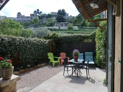 a patio with chairs and a table with a view at Holiday Home L'Olivier by Interhome in Ménerbes