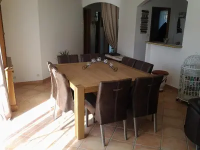 a dining room table with brown chairs around it at Maison les pins in Vedène