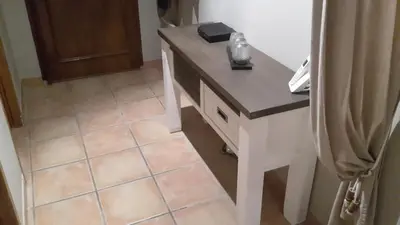 a kitchen with a counter and a tile floor at Maison les pins in Vedène
