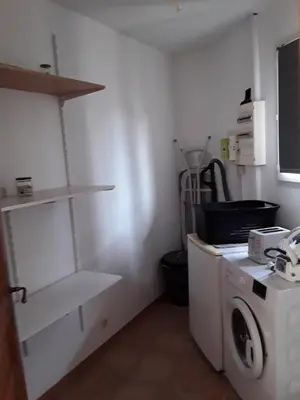 a kitchen with a washer and a washing machine at Maison les pins in Vedène