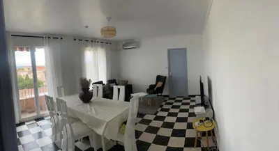 a dining room with a table and a checkered floor at Ogooué appartement entier Lumineux 94m2 in Carpentras
