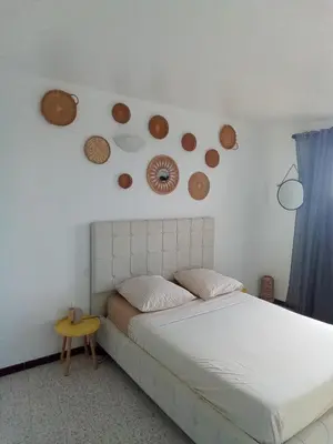 a bedroom with a bed and some plates on the wall at Ogooué appartement entier Lumineux 94m2 in Carpentras