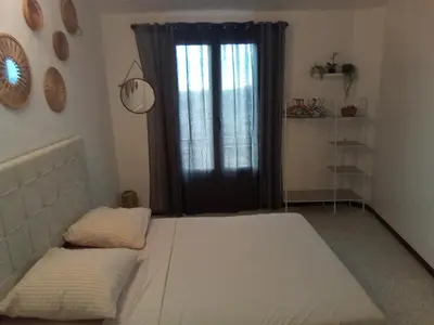 a room with two beds in front of a window at Ogooué appartement entier Lumineux 94m2 in Carpentras