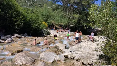 a group of people standing on rocks in a river at Le Mas de la Tortue (Toit Terrasse) in Caromb