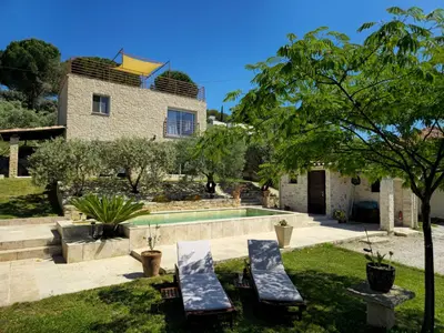 a villa with a swimming pool and a house at Le Mas de la Tortue (Toit Terrasse) in Caromb