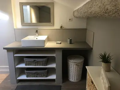 a bathroom vanity with a sink and a mirror at La Bastide des Songes - Demeure d'hôtes in Robion en Luberon