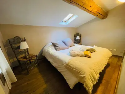a bedroom with a large bed in a attic at La Bastide des Songes - Demeure d'hôtes in Robion en Luberon
