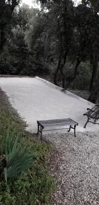 a park bench sitting on the side of a road at Le Bastion des Papes in Châteauneuf-de-Gadagne