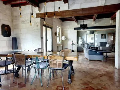 a dining room with a table and chairs and a couch at Le Bastion des Papes in Châteauneuf-de-Gadagne