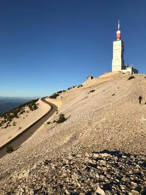 a lighthouse on top of a hill with a road at Gite Les Enfantines in Bédoin