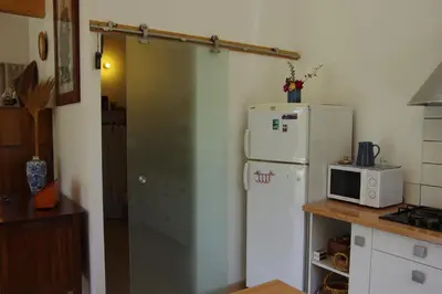 a kitchen with a refrigerator and a microwave at Chez MiLy in Sénas