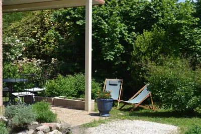 a couple of chairs sitting in a garden at Chez MiLy in Sénas