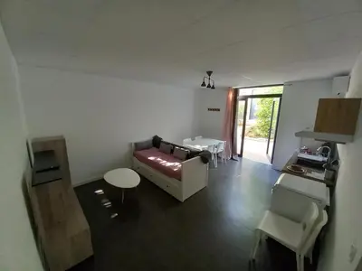 a living room with a couch and a table at Le Clos la Verdière in Velaux