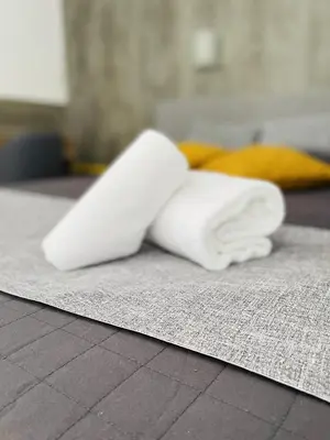 a pile of white towels sitting on a rug at Le Clos la Verdière in Velaux