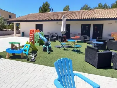 a yard with chairs and tables and chairs at Le Clos la Verdière in Velaux