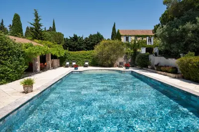 a swimming pool in the backyard of a house at Mas des Prevots B&B in Noves