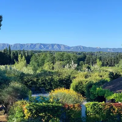 a view of a garden with mountains in the background at Mas des Prevots B&B in Noves